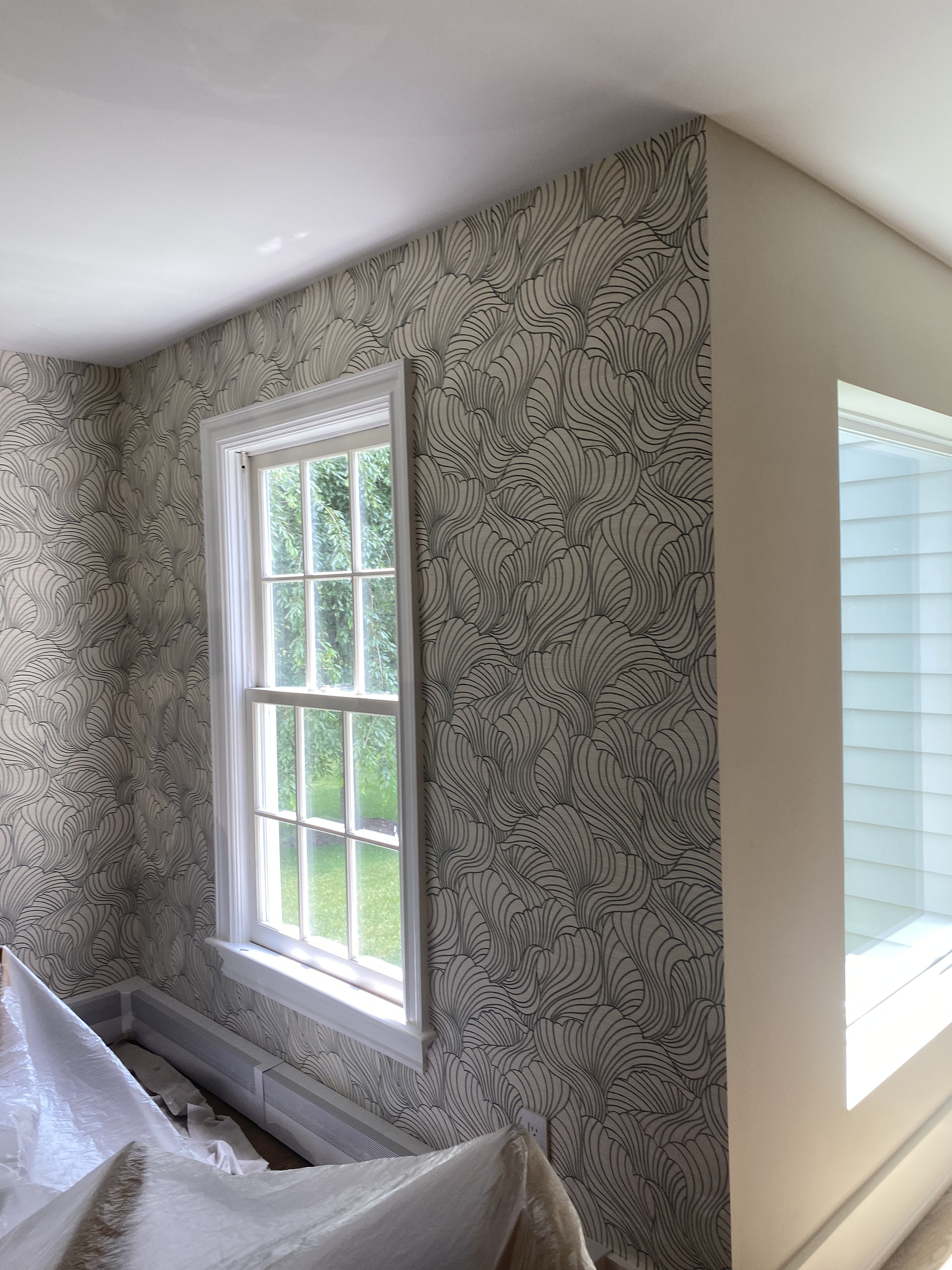 A beautifully patterned wallpaper in a bedroom.